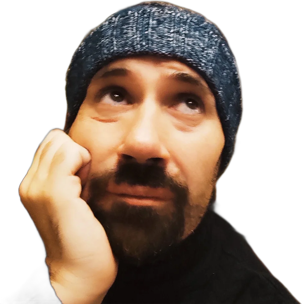Paolo Pedrazzi in a cap, hand on his face, deep in thought